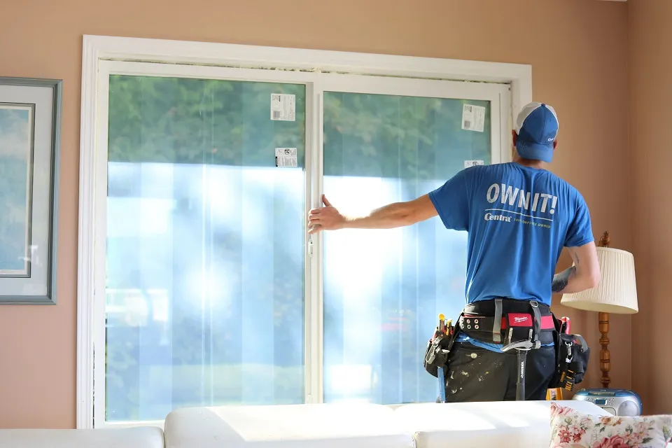 man installing window